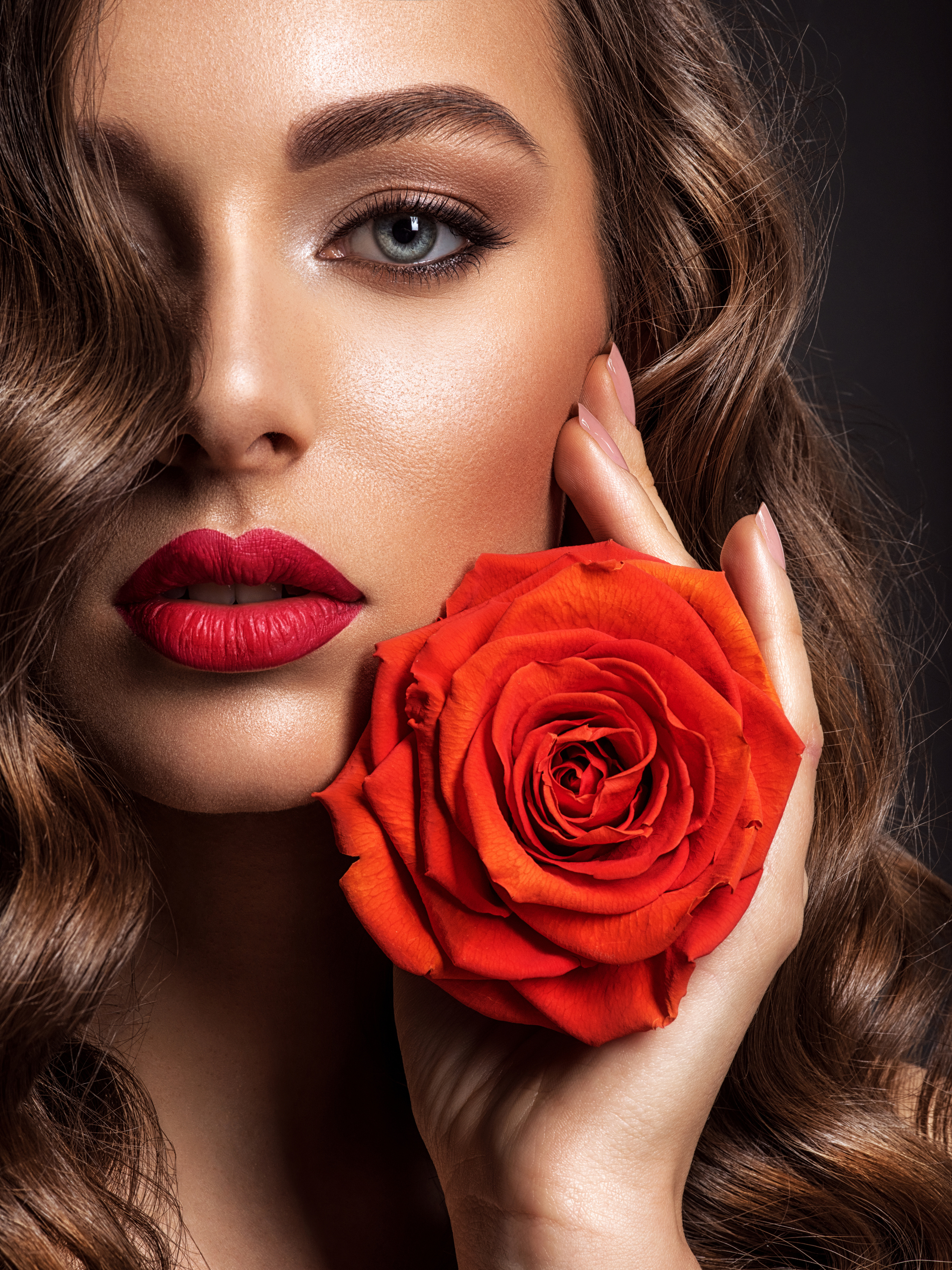 A Female Model Holding a Red Rose