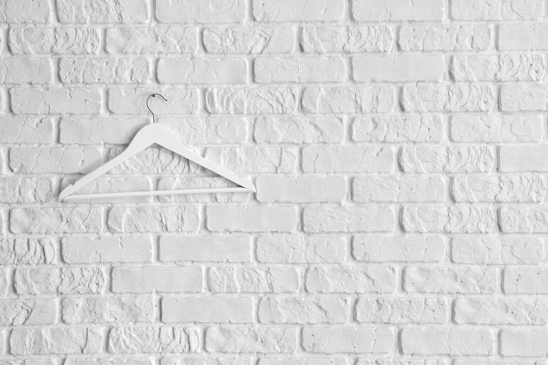 Clothes Hanger on White Brick Wall