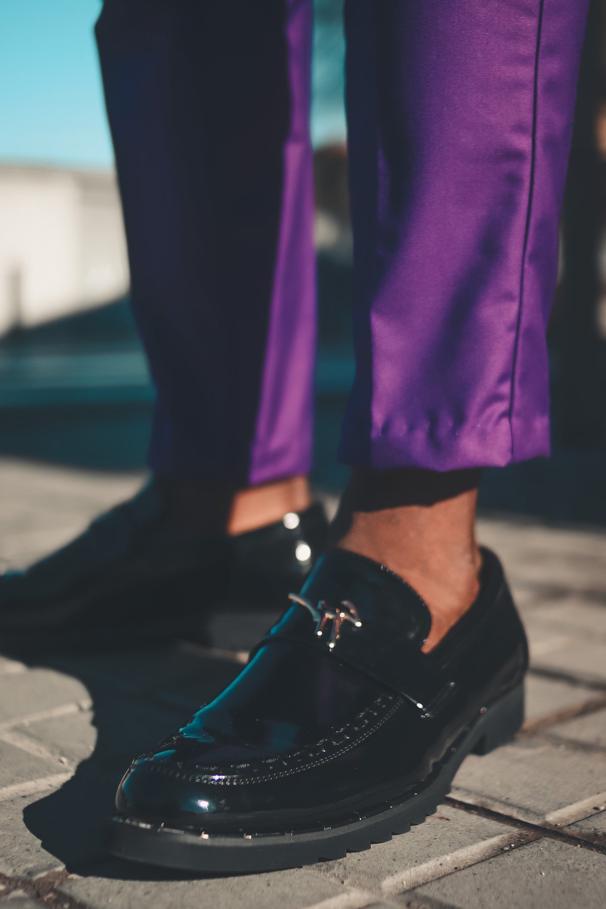 Person in Purple Pants Wearing Black Leather Shoes